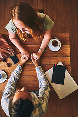 Image showing Above, couple and coffee shop with holding hands, love and conversation for romance at table. Man, woman and valentines date in cafe for support, bonding and talking with happiness, care and trust