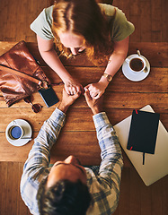 Image showing Couple holding hands, love and date at coffee shop on Valentines day, trust and care, wood table top view..People in cafe, support and respect with commitment . and together in relationship