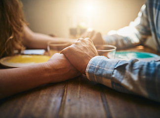 Image showing Love, couple and holding hands at restaurant on table, for care and bonding together. Valentines day, romance and affection, passion of man and woman on romantic date enjoying quality time in cafe.