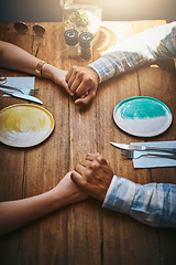 Image showing Love, couple and top view of holding hands at restaurant on table for care and bonding. Valentines, diversity and affection, passion of man and woman on romantic date enjoying quality time in cafe.