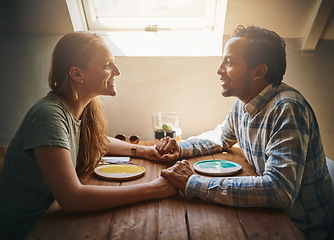 Image showing Love, couple and holding hands at cafe on table, talking and bonding together. Valentines day, romance diversity and affection of man and woman on date, having fun or enjoying time in restaurant.