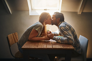 Image showing Kiss, couple love and holding hands at cafe on table, passion or bonding together. Valentines day, romance diversity and affection of man and woman on date, kissing and enjoying time in restaurant.