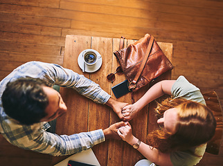 Image showing Top view, couple and cafe with holding hands, love and conversation for romance at table. Man, woman and valentines date in coffee shop for support, bonding and talking with happiness, care and trust