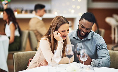 Image showing Date, laughing and interracial couple with wine in fine dining, luxury restaurant or valentines celebration together. Funny black man, happy woman and alcohol glasses for romance, rich or anniversary