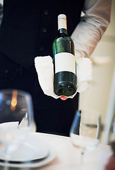 Image showing Waiter, table and server hand with wine and hospitality holding alcohol bottle. Bartender, drink and service of a barman at a fine dining restaurant with staff hands and glasses for drinking