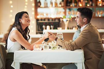 Image showing Happy couple holding hands, restaurant and dinner date on Valentines day, celebrate holiday with love, care and romance. Commitment, interracial relationship and man with woman, trust and support