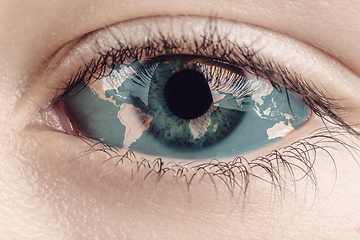 Image showing Earth continents painted on eye iris