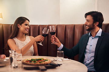 Image showing Wine, cheers and valentines day with a couple in a restaurant for celebration of love, romance and fine dining. Alcohol, roast or anniversary with a young man and woman on a romantic date together