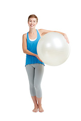 Image showing Portrait, workout and woman with fitness ball for wellness and health isolated against a studio white background. Exercise, training and fit happy female ready for healthy body and lifestyle