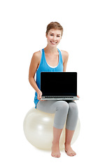Image showing Laptop mockup, fitness and woman isolated on a white background sitting on balance ball and pc screen. Happy model or person with computer mock up space for advertising or product placement in studio