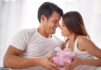 Image showing Man giving woman gift box, love and happiness with partnership, relationship and celebration on Valentines day date. Couple smile with present, luxury and commitment, gratitude and celebrate holiday