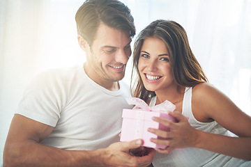 Image showing Couple, gift or present for valentines day portrait celebration with love, care and surprise in bedroom. Man and woman in happy home with box for birthday, holiday or luxury with smile for gratitude