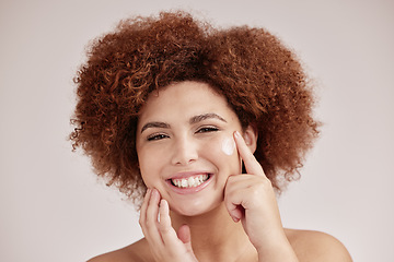 Image showing Skincare, beauty and portrait of woman with cream on face, smile and afro, advertising luxury skin product promotion. Dermatology, cosmetics and facial for happy model isolated on studio background.