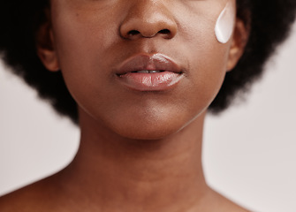 Image showing Black woman, face and cream of a model with facial mask, skincare and sunscreen in studio. Isolated, white background and self care treatment of a young person with cosmetic and collagen lotion