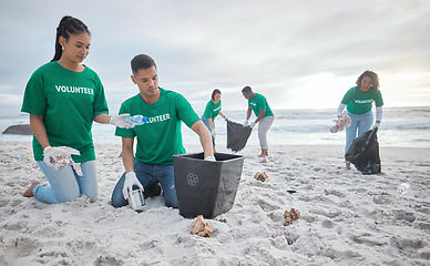 Image showing Collaboration, charity and recycling with people on beach for sustainability, environment and eco friendly. Climate change, earth day and nature with volunteer and box for help, energy and pollution