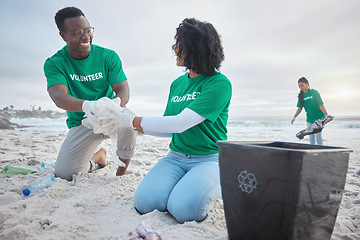 Image showing Teamwork, happy and recycling with people on beach for sustainability, environment and eco friendly. Climate change, earth day and nature with volunteer and plastic for help, energy and pollution