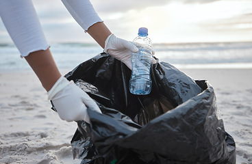 Image showing Cleaning, plastic and hands of woman at beach for recycle, environment or earth day. Recycling, sustainability and climate change with charity volunteer and trash for pollution and eco friendly