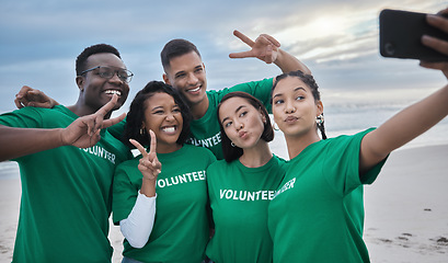 Image showing Peace sign, selfie and volunteer with people on beach for sustainability, environment or climate change. Diversity, earth day and social media with friends and phone for technology, energy or charity