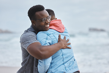 Image showing Friendship, love and men hugging on the beach for a reunion while on a summer vacation or holiday. Happy, smile and loving gay couple embracing by the ocean while on a seaside weekend trip in Hawaii.