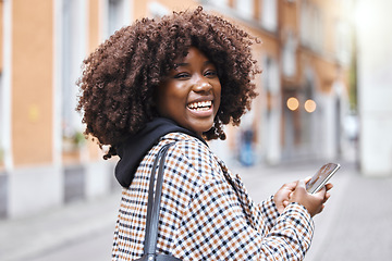 Image showing Phone, happy and portrait of a black woman in the city networking on social media, mobile app or internet. Happiness, smile and African female typing a message on a cellphone while walking in town.