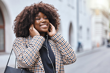 Image showing Happy, city and black woman listening to music, radio or song in the street while walking to work. Happiness, smile and African female streaming a playlist, album or audio with earphones in the road.