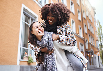 Image showing Girl friends, laughing and city travel adventure of young people with a piggyback and happiness. Freedom, diversity and women smile outdoor feeling happy on a walk on a urban holiday together