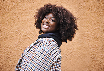Image showing Black woman, portrait and smile on wall background in city, urban town and Kenya. Happy plus size african female with natural afro, happiness and confidence outdoors with fashion, relax and freedom