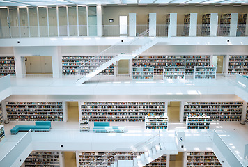 Image showing Library, interior design and university for education, learning and knowledge building background. Campus, bookshelf, architecture and empty room or stairs space for learning, scholarship or research