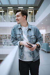 Image showing Education, college and man student in the library for studying, learning or researching for a test. University, scholarship and male standing in a book store to work on a school task, exam or project