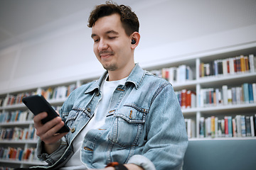 Image showing Library, man and smartphone for typing, music and relax on weekend, student and connection for social media. Male, gentleman and guy with cellphone, listening to audio and podcast with smile and joy