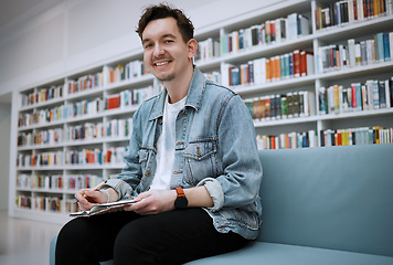 Image showing Student man, library portrait and writing on sofa with smile, happy and focus on education at college. University student, pen and notebook for notes, goals and ideas for studying, research and task