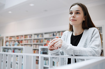 Image showing University, thinking and woman in library for knowledge, learning and academic research in building. Education, college and young female student with ideas, vision and happy mindset for future goals