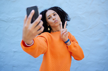 Image showing Selfie, pose and woman by a wall in the city while on a travel holiday or weekend trip in Mexico. Freedom, peace sign and female taking a picture with a hand gesture in a urban town on a vacation.