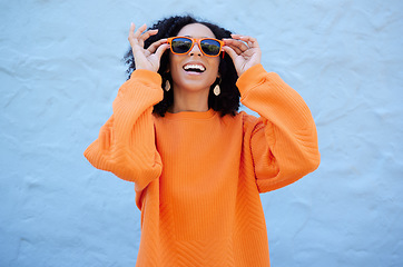 Image showing Fashion, sunglasses and black woman isolated on blue background of gen z, youth or cool trendy clothes. Happy person or beauty model for confidence, vision style and orange color streetwear on mockup