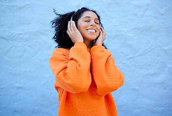 Image showing Happiness, black woman and headphones for streaming, music and cheerful on blue studio background. African American female, lady or headset for audio, sounds and podcast with girl, smile and backdrop