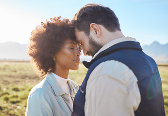 Image showing Intimacy, love and couple in nature on a farm for a romantic anniversary or valentines day date. Intimate, affection and interracial man and woman in a romance moment together on a eco friendly field