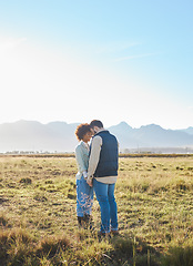 Image showing Love, interracial and couple on countryside vacation, holding hands and joyful outside with romantic view. Romance, happy man and black woman on field, holiday and weekend break, happiness or support