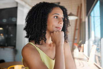 Image showing Face, thinking and a black woman waiting in a coffee shop for her order or date while feeling bored. Idea, alone or window and an attractive young female sitting in a cafe with her hand on her chin