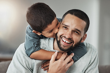 Image showing Happy, love and child kissing his father while relaxing in the living room at their family home. Happiness, smile and portrait of a young man hugging and bonding with boy kid with care and in house.