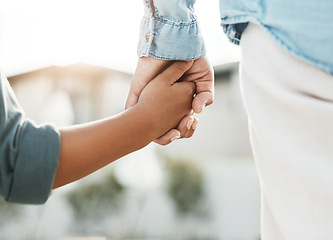 Image showing Love, care and mother and child holding hands in the city for safety, support and trust in Switzerland. Help, compassion and back of a kid and parent walking outdoors with guidance and affection