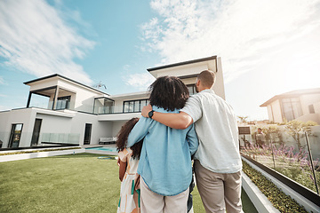 Image showing Love, new home and family standing in their backyard looking at their property or luxury real estate. Embrace, mortgage and parents with their children on grass at their house or mansion in Canada.