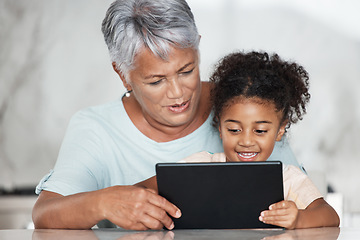 Image showing Grandmother, learning and girl with tablet in home for streaming video, movie or social media. Bonding, touchscreen and care of happy grandma with child watching film or web browsing on technology.