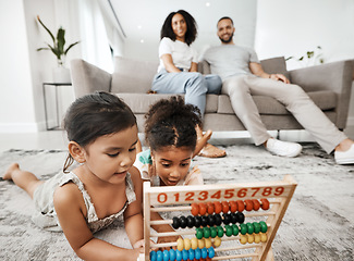 Image showing Family home, children and floor with abacus for math learning, development and sibling teamwork. Children, carpet and education toys with mom, dad and sofa with smile, pride and happiness in house