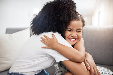 Image showing Love, hug and girl with mother on a sofa, happy and smile while hugging in their home together. Family, embrace and parent with child on a couch, bond and cheerful, loving and caring in a living room