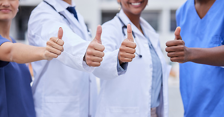 Image showing Doctor, thumbs up and medical teamwork with hands, smile or support for healthcare, wellness and mockup. Group, doctors and diversity with yes sign, team building or vision with solidarity for health