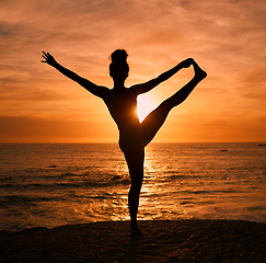 Image showing Yoga, stretching and silhouette of woman on beach at sunrise for exercise, training and pilates workout. Motivation, meditation and shadow of girl balance by ocean for sports, wellness and fitness