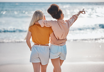 Image showing Woman, friends and hug in relax at the beach for summer vacation, travel or journey together in the outdoors. Interracial women hugging and enjoying trip, traveling or adventure by the ocean coast