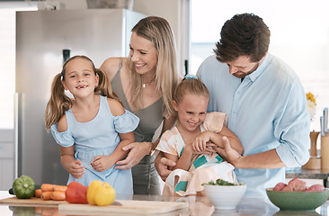 Image showing Fun, playful and family cooking food, bonding and children helping in the kitchen for lunch. Happy, laughing and parents playing with girl kids while preparing dinner together for quality time