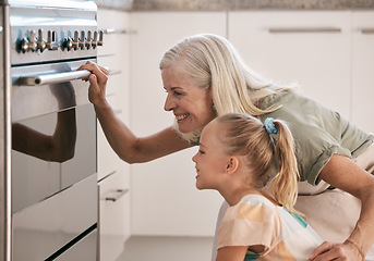 Image showing Baking, kitchen and grandmother with a child by the oven watching the cake, cookies or pie bake. Happy, smile and senior woman with a girl kid cooking for dinner, party or event at their home.