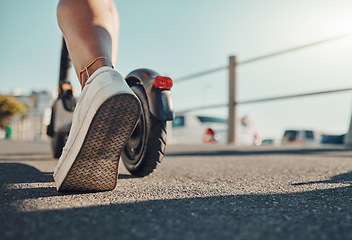 Image showing Foot, scooter and travel with eco friendly transportation outdoor, sustainability and sneakers on asphalt in city. Person with sustainable transport in Miami, carbon footprint mockup and adventure